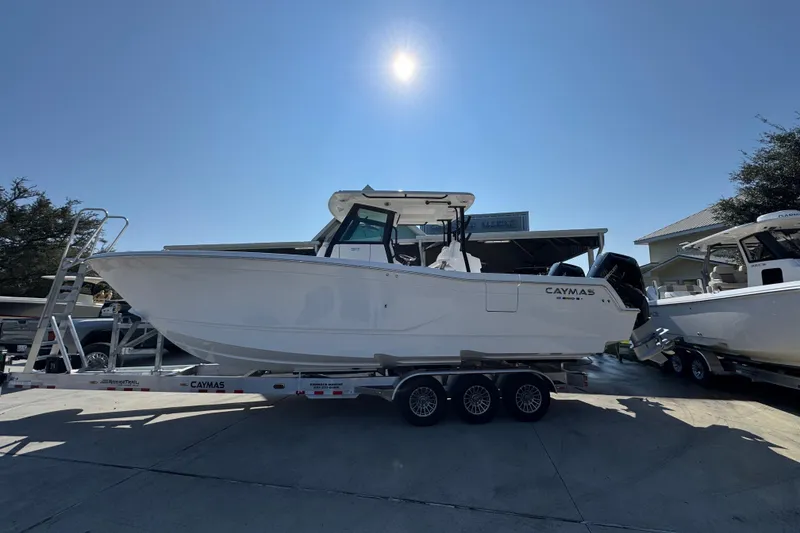 The Image of 2026 Caymas 30 CT boat on trailer under bright sun. - 1