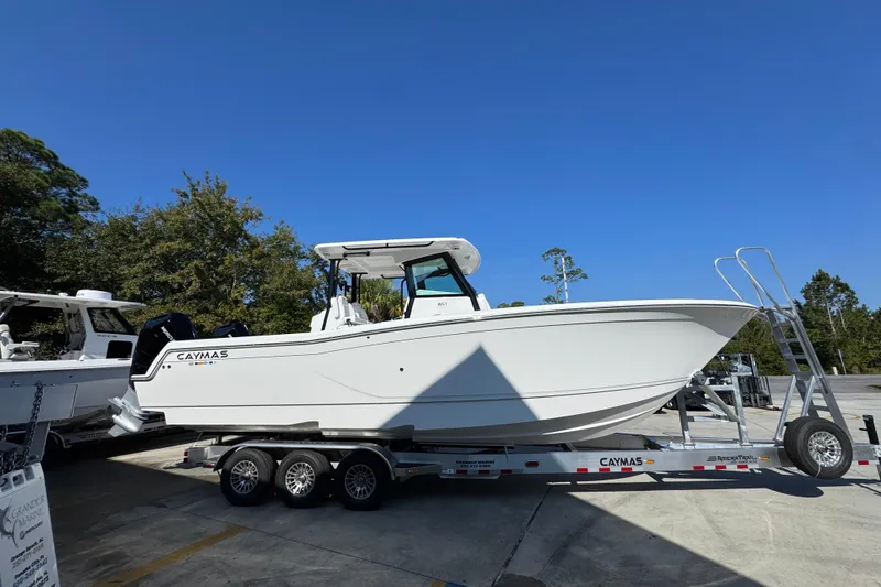 Slide: The Image of 2026 Caymas 30 CT boat on trailer under clear blue sky. - 10