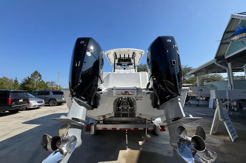 Slide: The Image of 2026 Caymas 30 CT boat with dual outboard engines on a trailer. - 13