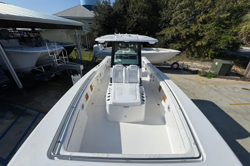 Slide: The Image of 2026 Caymas 30 CT boat with spacious deck and modern design in a marina setting. - 17