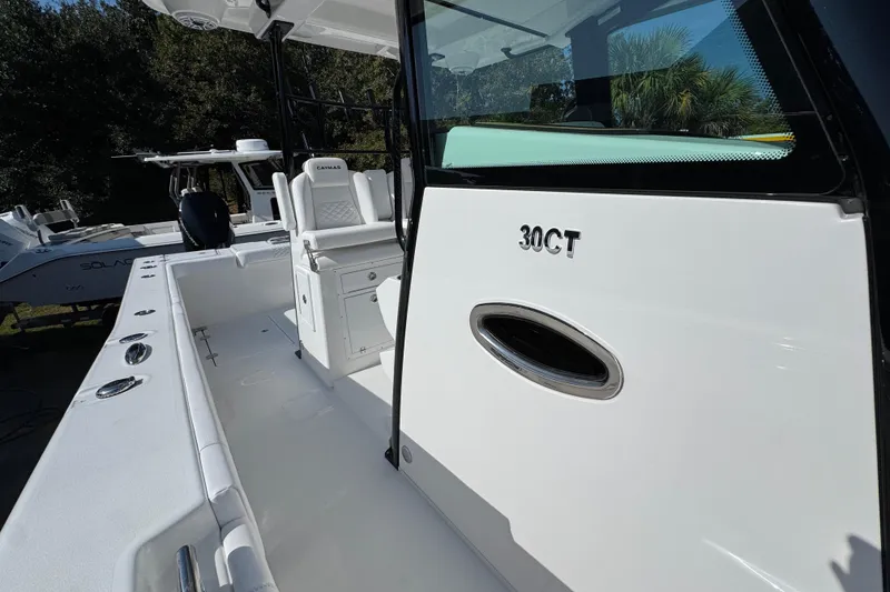 Slide: The Image of 2026 Caymas 30 CT boat interior with seating and console details. - 22