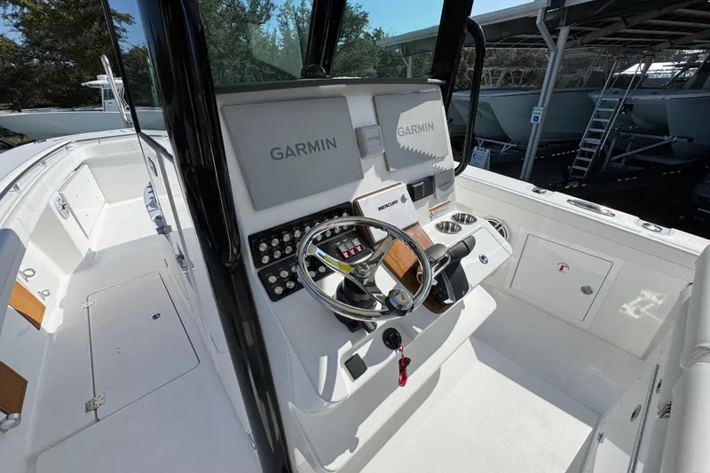 Slide: The Image of 2026 Caymas 30 CT boat cockpit with Garmin navigation system and steering wheel. - 29
