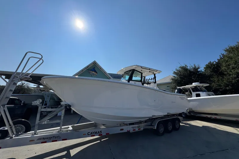 Slide: The Image of 2026 Caymas 30 CT boat on trailer under clear blue sky. - 3