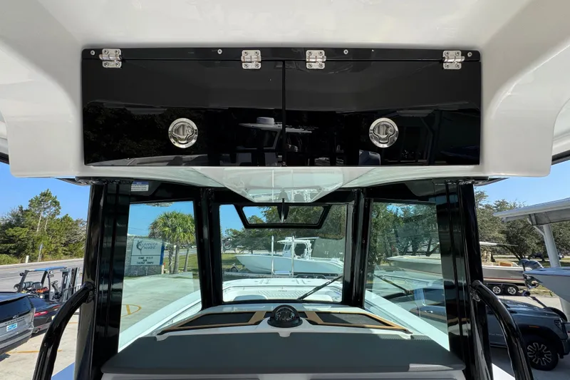 Slide: The Image of 2026 Caymas 30 CT boat interior with overhead storage and windshield view. - 32