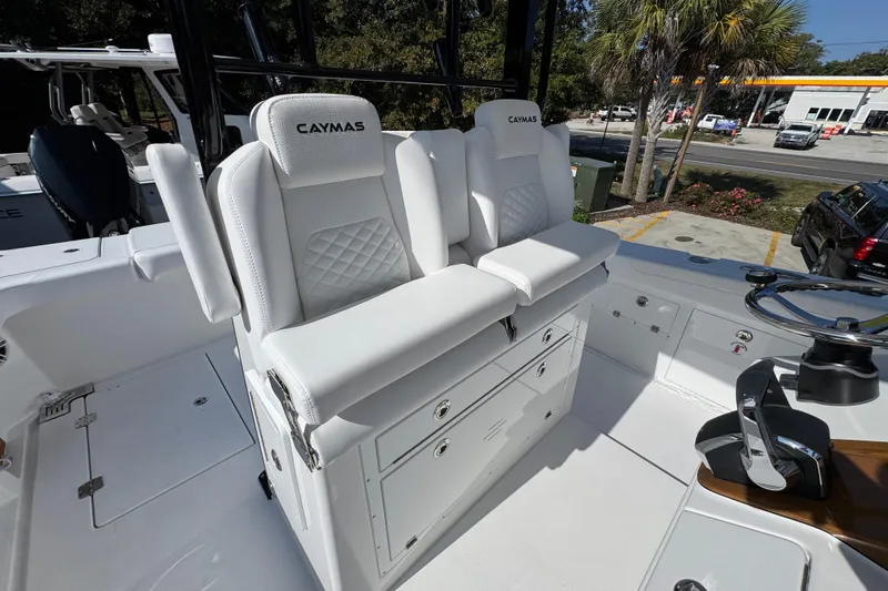 Slide: The Image of 2026 Caymas 30 CT boat interior with white seating and storage compartments. - 34
