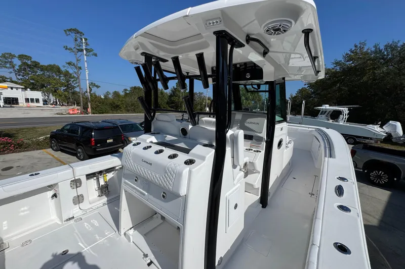 Slide: The Image of 2026 Caymas 30 CT boat with sleek design and modern features, parked outdoors. - 38