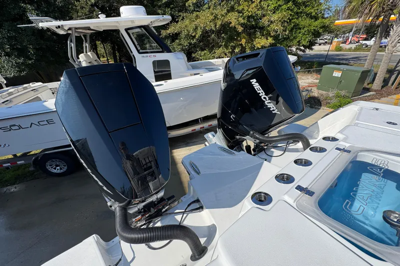 Slide: The Image of 2026 Caymas 30 CT boat with dual Mercury outboard engines, docked outdoors. - 43