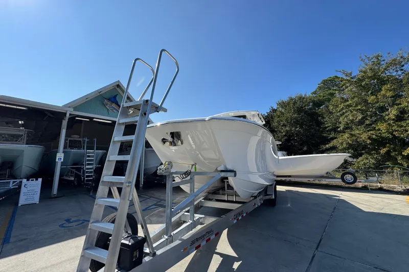 Slide: The Image of 2026 Caymas 30 CT boat on trailer under clear blue sky. - 5