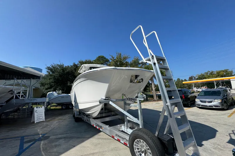 Slide: The Image of 2026 Caymas 30 CT boat on trailer under clear blue sky. - 7