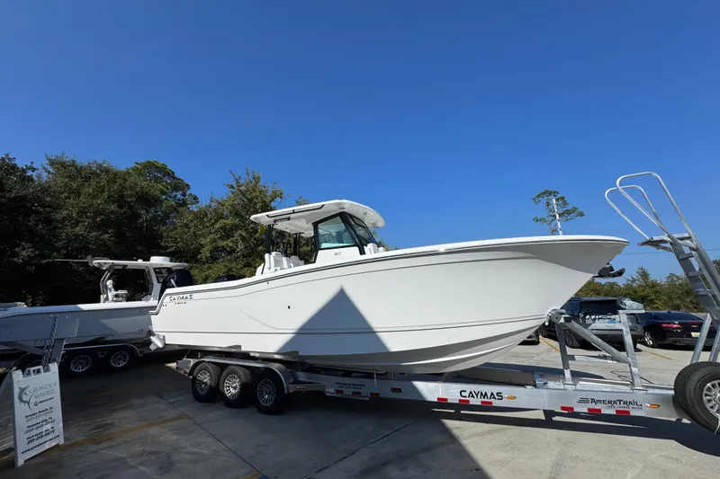 Slide: The Image of 2026 Caymas 30 CT boat on trailer under clear blue sky. - 9
