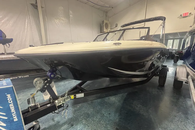 Slide: The Image of 2026 Bayliner M17 boat on trailer in indoor showroom. - 2