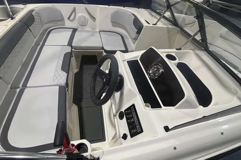 Slide: The Image of 2026 Bayliner M17 boat interior with steering wheel and seating area. - 7