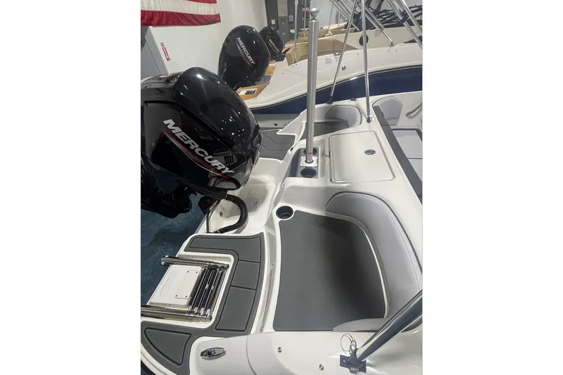 Slide: The Image of 2026 Bayliner M17 boat interior with Mercury engine, showcasing seating and storage areas. - 8