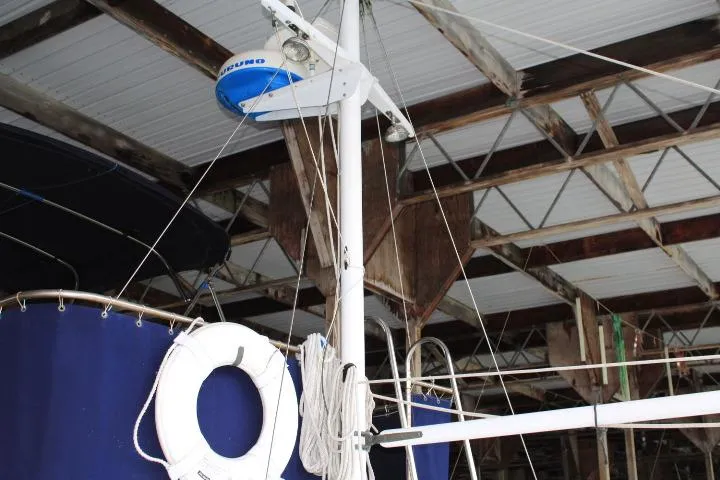 Slide: The Image of 1976 CHB Double Cabin Trawler in a boat shed, featuring a life ring and radar equipment. - 22