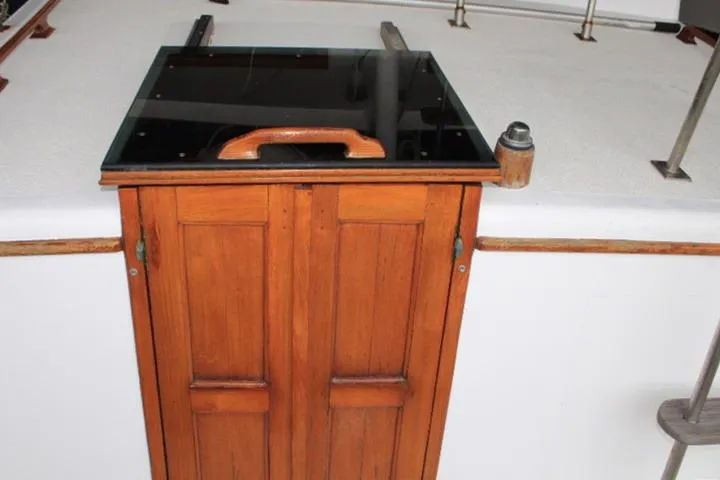 Slide: The Image of Wooden hatch on 1976 CHB Double Cabin Trawler, featuring a glass top and handle. - 32