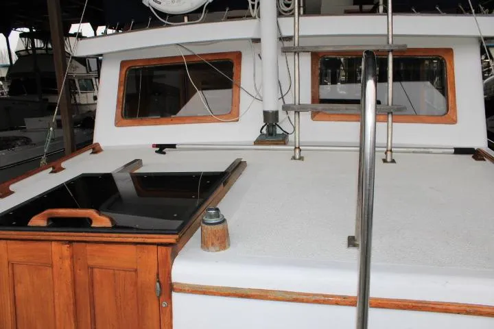 Slide: The Image of 1976 CHB Double Cabin Trawler with wooden accents and deck details. - 33