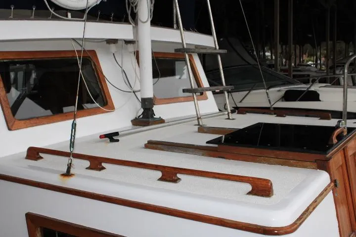 Slide: The Image of 1976 CHB Double Cabin Trawler with wooden accents and deck details. - 34
