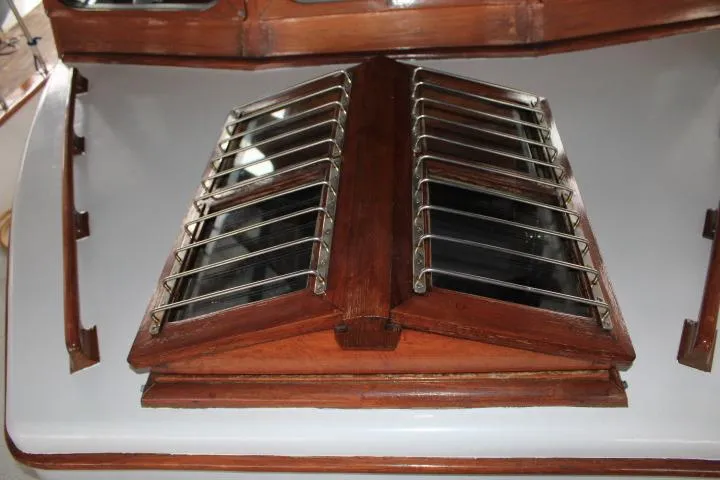 Slide: The Image of 1976 CHB Double Cabin Trawler with wooden hatch and metal bars. - 37