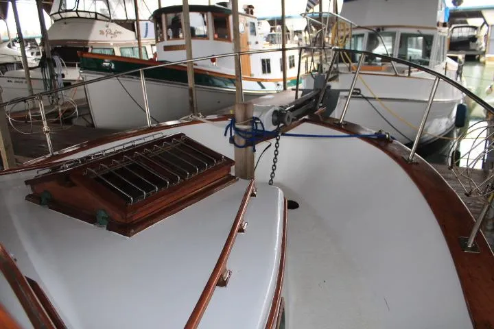 Slide: The Image of 1976 CHB Double Cabin Trawler docked, showcasing deck and railing details. - 38