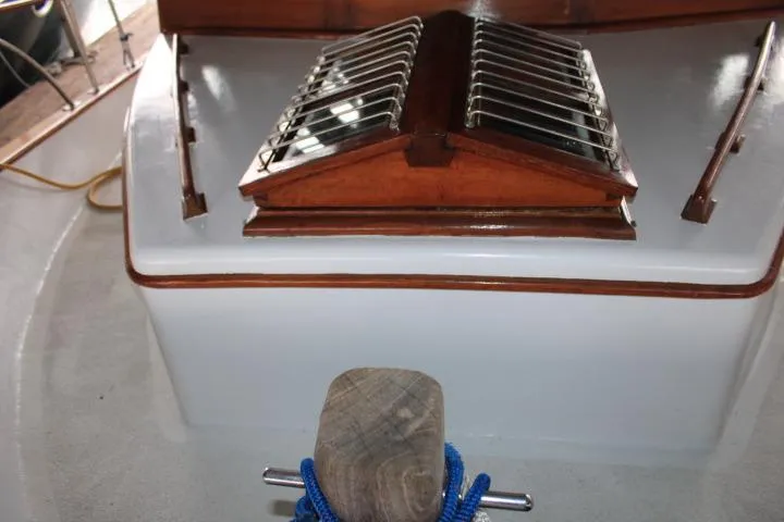 Slide: The Image of 1976 CHB Double Cabin Trawler deck with wooden hatch and blue rope. - 39
