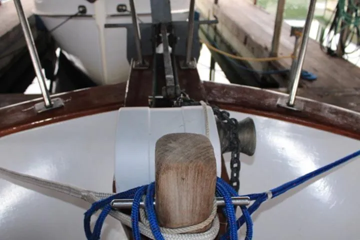 Slide: The Image of 1976 CHB Double Cabin Trawler bow with anchor chain and ropes in a dock. - 40