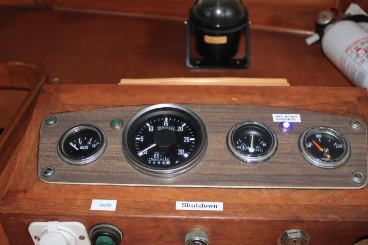 Slide: The Image of 1976 CHB Double Cabin Trawler dashboard with gauges and controls. - 44