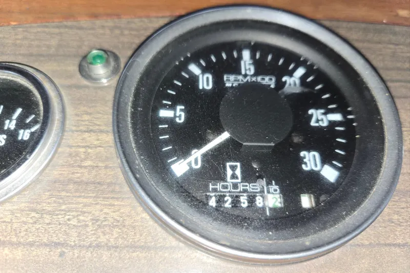 Slide: The Image of Close-up of a 1976 CHB Double Cabin Trawler tachometer showing RPM and engine hours. - 45