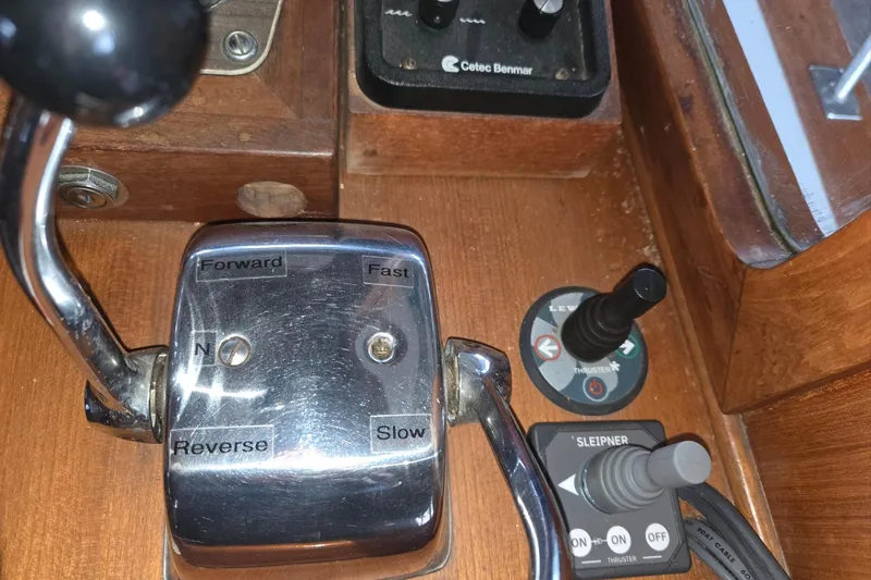 Slide: The Image of Control panel of a 1976 CHB Double Cabin Trawler with throttle and thruster controls. - 46