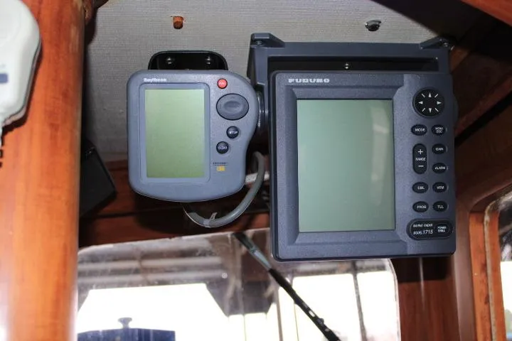 Slide: The Image of Navigation equipment inside a 1976 CHB Double Cabin Trawler, featuring Raytheon and Furuno displays. - 47