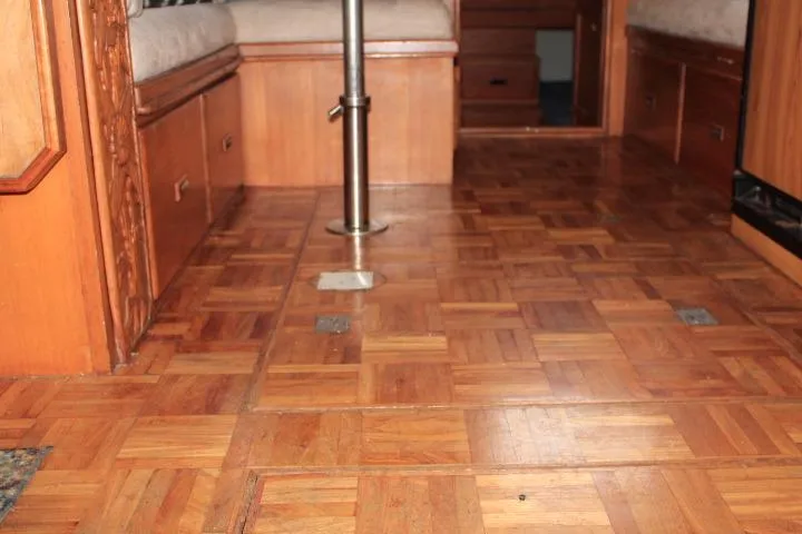 Slide: The Image of 1976 CHB Double Cabin Trawler interior with wooden parquet flooring and built-in seating. - 51