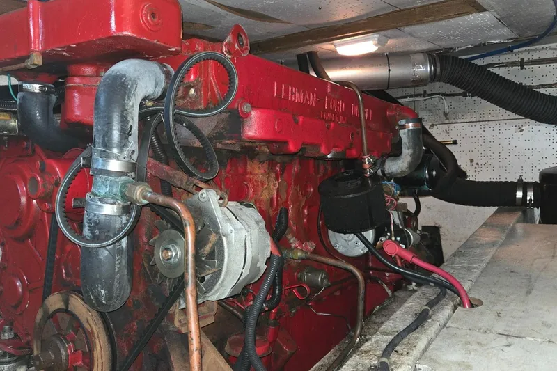 Slide: The Image of Engine room of a 1976 CHB Double Cabin Trawler with red marine engine. - 55