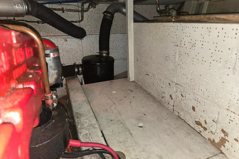 Slide: The Image of Engine room of 1976 CHB Double Cabin Trawler with visible components and piping. - 56