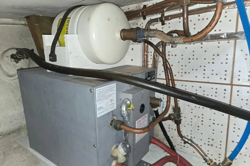 Slide: The Image of Engine room of 1976 CHB Double Cabin Trawler with plumbing and equipment. - 60