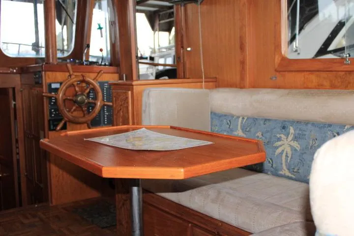 Slide: The Image of Interior of 1976 CHB Double Cabin Trawler with wooden table and nautical decor. - 65