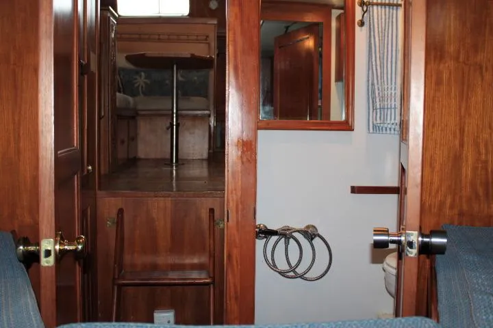 Slide: The Image of 1976 CHB Double Cabin Trawler interior with wood finish and nautical decor. - 81