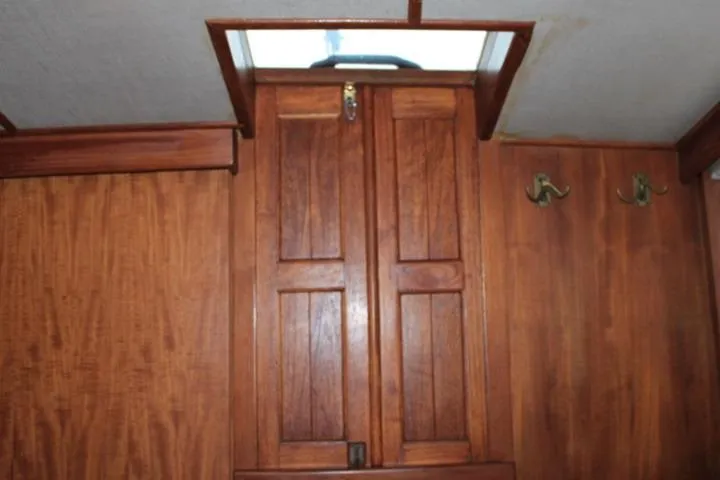 Slide: The Image of Wooden interior of 1976 CHB Double Cabin Trawler with closed hatch and hooks. - 86