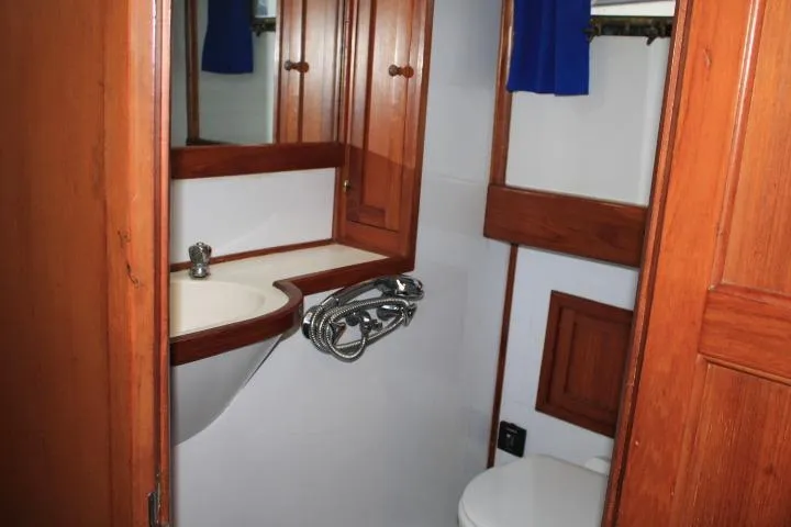 Slide: The Image of Bathroom interior of 1976 CHB Double Cabin Trawler with wooden cabinetry and sink. - 93