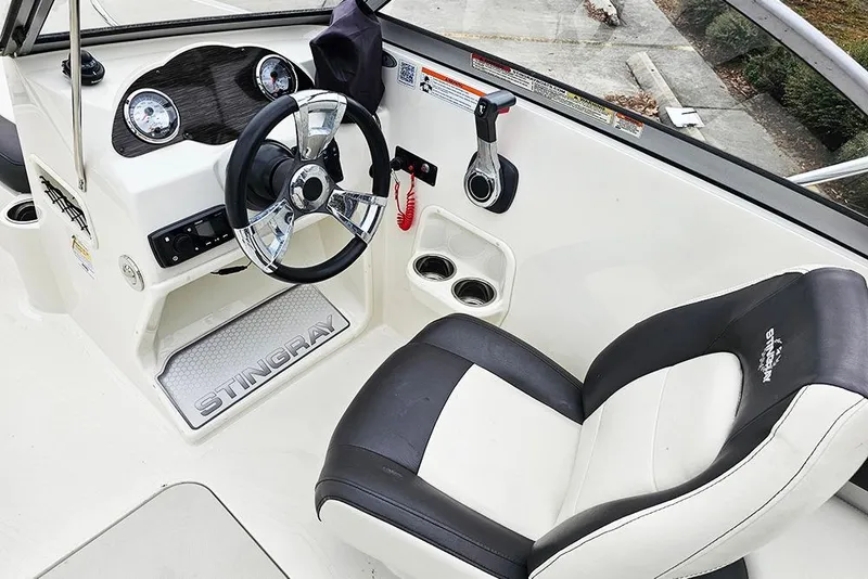 Slide: The Image of 2019 Stingray 191 DC boat interior with steering wheel and captain's seat. - 12