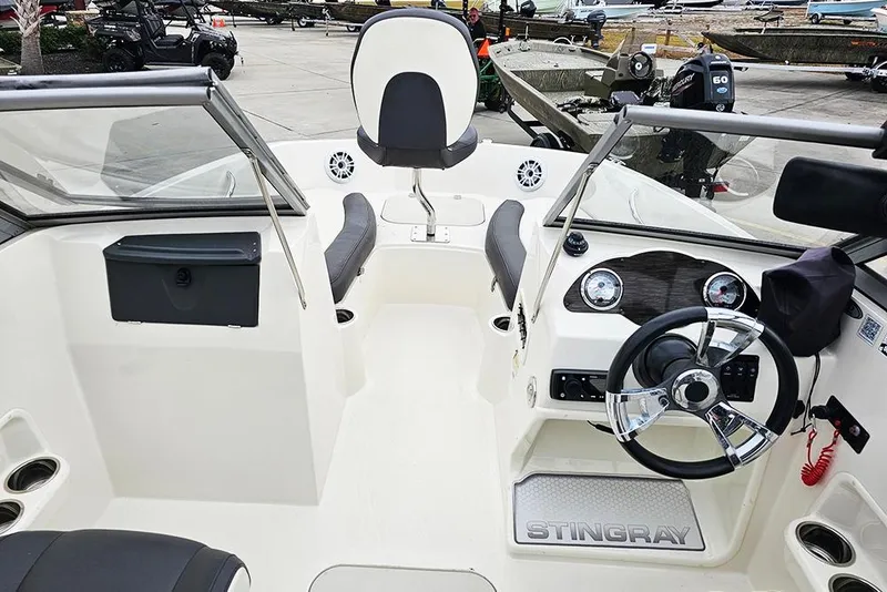 Slide: The Image of 2019 Stingray 191 DC boat interior with steering wheel and seating. - 15