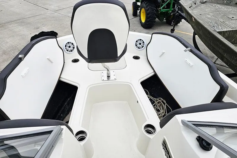Slide: The Image of 2019 Stingray 191 DC boat interior with open storage compartments and seating. - 16