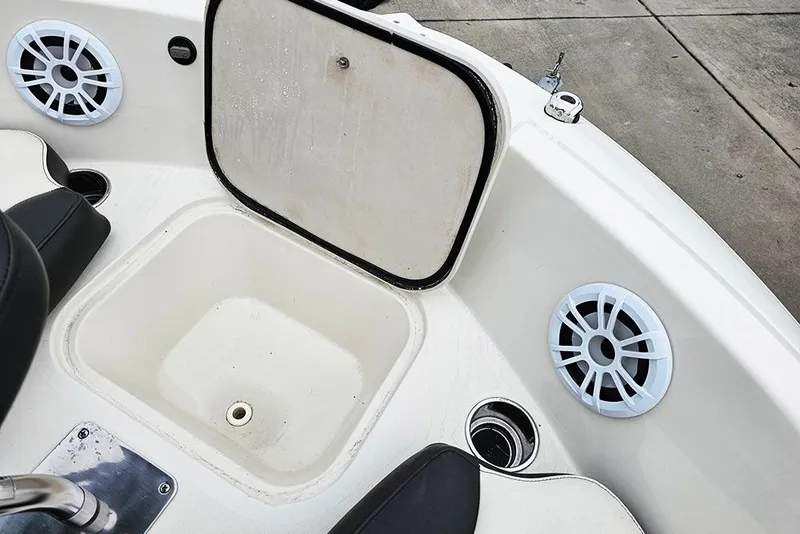 Slide: The Image of 2019 Stingray 191 DC boat interior with speakers and storage compartment. - 17