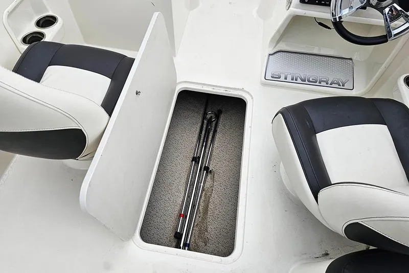 Slide: The Image of 2019 Stingray 191 DC boat interior with storage compartment and seating. - 20
