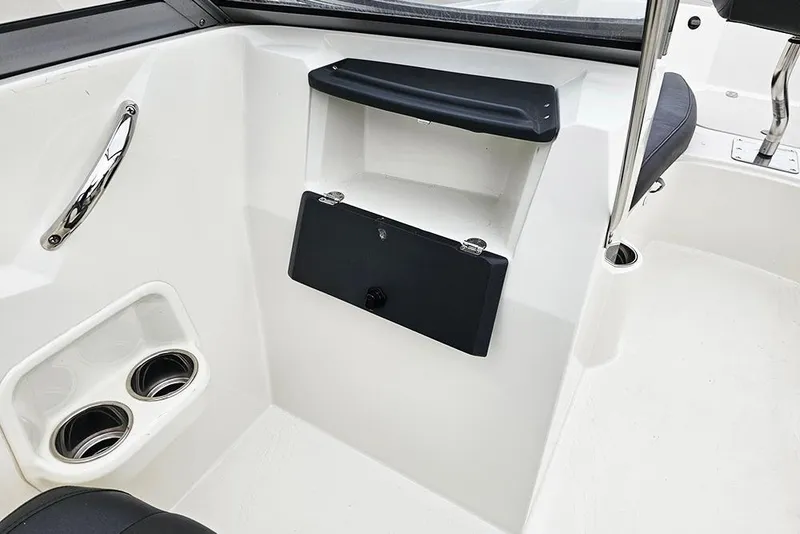 Slide: The Image of 2019 Stingray 191 DC boat interior with cup holders and storage compartment. - 21