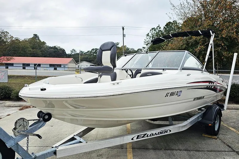 Slide: The Image of 2019 Stingray 191 DC boat on trailer, parked outdoors. - 3