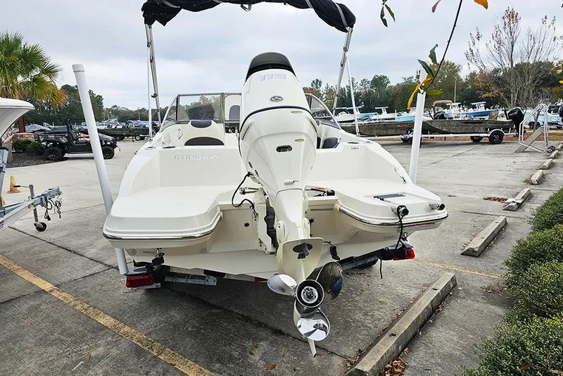 Slide: The Image of 2019 Stingray 191 DC boat with outboard motor in a parking lot. - 5