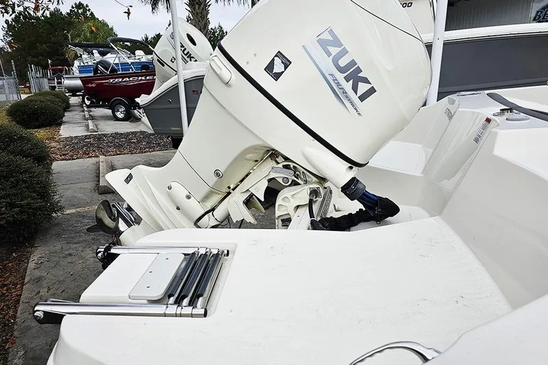 Slide: The Image of 2019 Stingray 191 DC boat with Zuki outboard motor in a marina setting. - 7