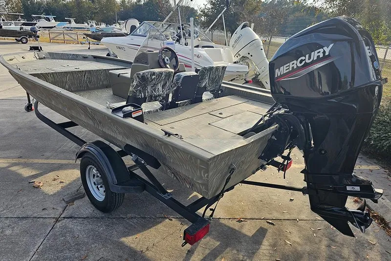 Slide: The Image of 2024 Tracker Grizzly 1754 SC boat with Mercury outboard motor on trailer. - 3