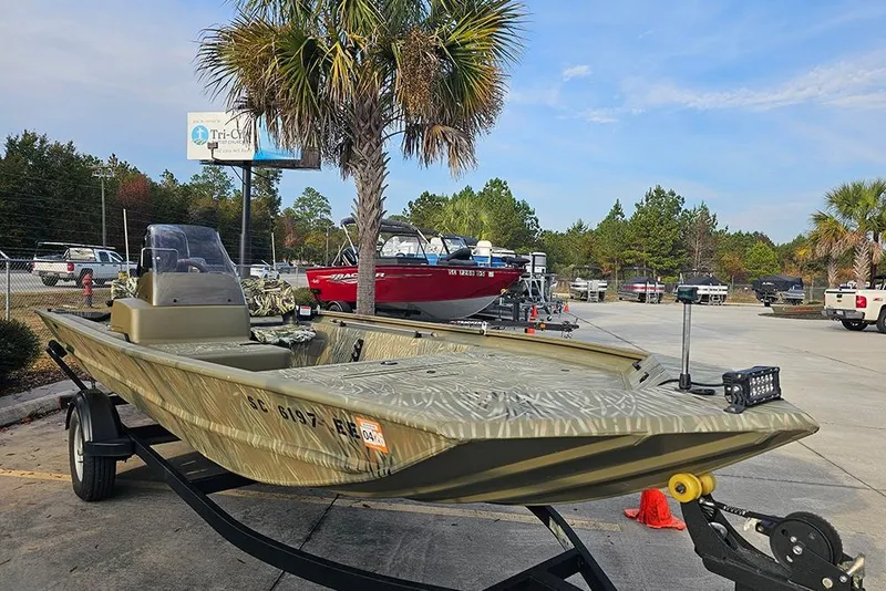 Slide: The Image of 2024 Tracker Grizzly 1754 SC boat on trailer in outdoor dealership setting. - 5