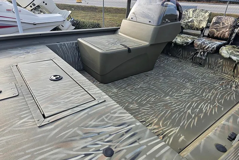 Slide: The Image of 2024 Tracker Grizzly 1754 SC boat interior with camouflage seating and flooring. - 9