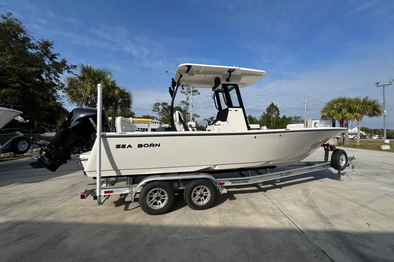 Slide: The Image of 2026 Sea Born LX24 Center Console boat on trailer, parked outdoors under blue sky. - 10